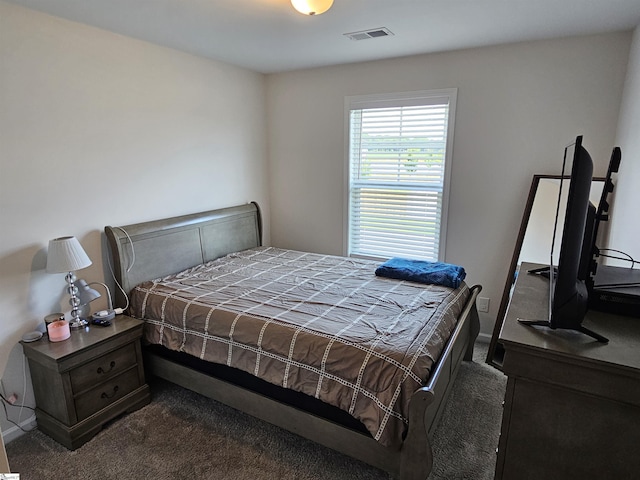 bedroom featuring dark carpet