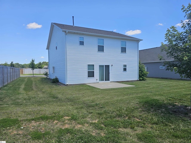 rear view of property with a patio and a yard