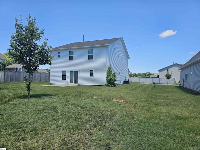 rear view of property with a patio area and a yard