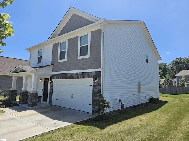 view of front of property with a garage, covered porch, and a front yard