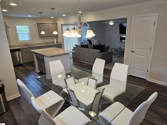 dining area featuring dark wood-type flooring, sink, and crown molding