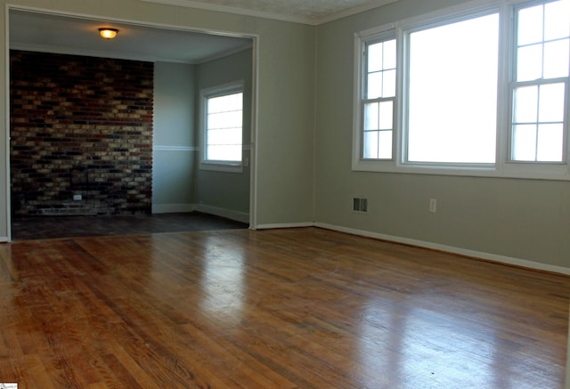 spare room featuring dark hardwood / wood-style flooring and crown molding