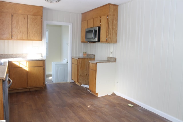 kitchen with separate washer and dryer and dark hardwood / wood-style flooring