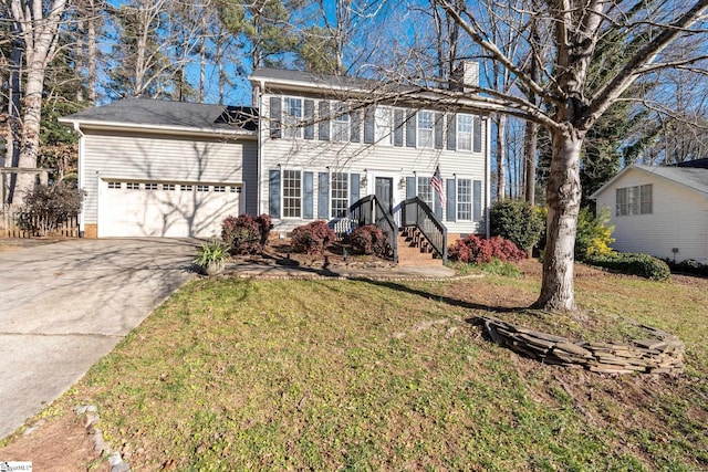 colonial house featuring a garage and a front lawn