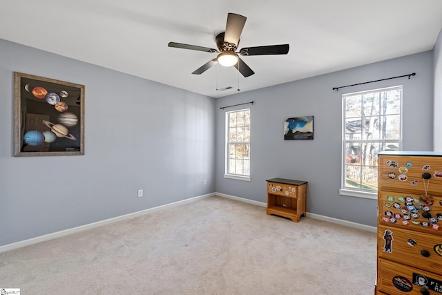 bedroom featuring light carpet, multiple windows, and ceiling fan