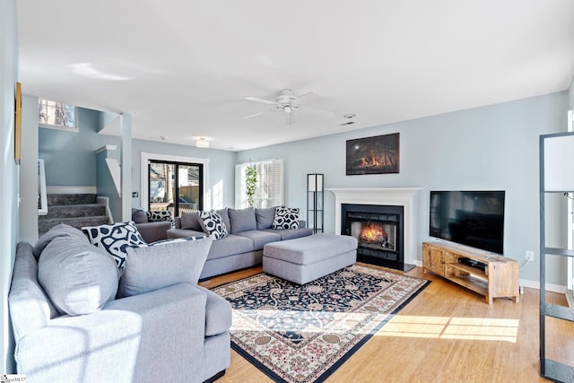 living room featuring hardwood / wood-style flooring and ceiling fan