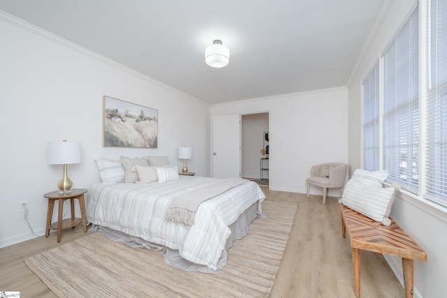 bedroom with light wood-type flooring and ornamental molding