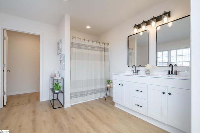 bathroom featuring hardwood / wood-style flooring and vanity