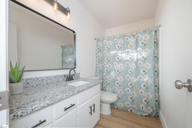 bathroom featuring hardwood / wood-style flooring, toilet, vanity, and a shower with shower curtain