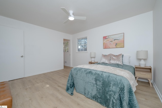 bedroom with light wood-type flooring and ceiling fan