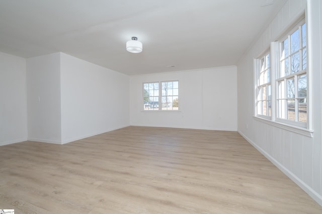 unfurnished room with light wood-type flooring