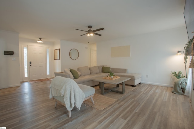 living room featuring ceiling fan and light hardwood / wood-style floors