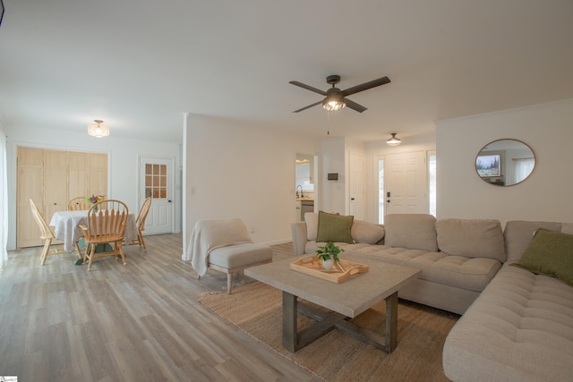 living room featuring hardwood / wood-style flooring and ceiling fan