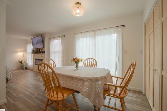 dining space featuring a healthy amount of sunlight and light hardwood / wood-style floors