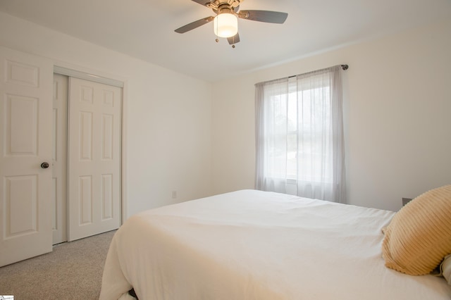 carpeted bedroom with a closet and ceiling fan