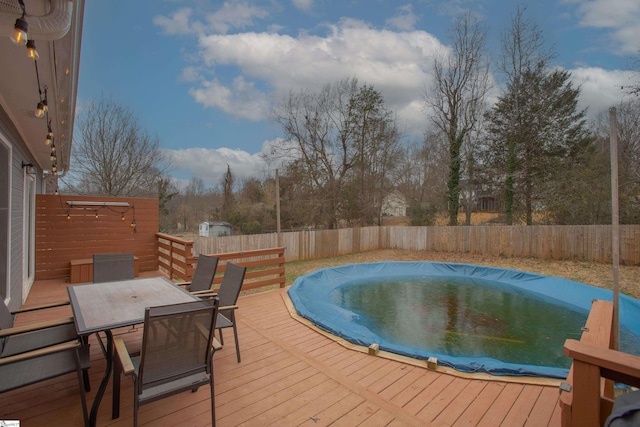 view of swimming pool with a wooden deck