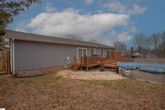 rear view of property with a swimming pool side deck