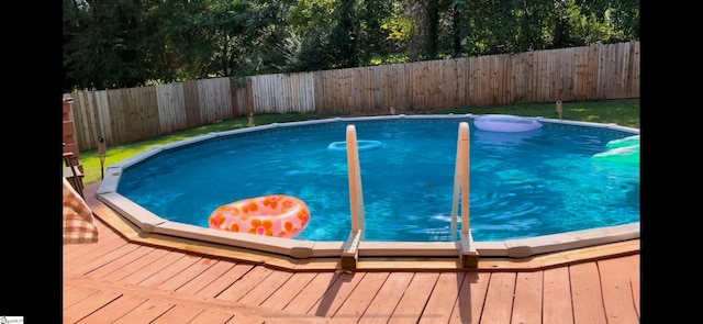 view of swimming pool with a wooden deck