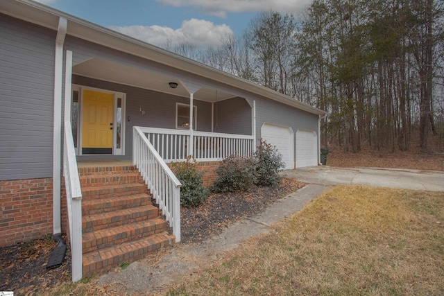 view of front of home featuring covered porch and a garage