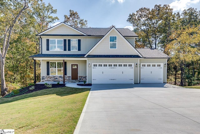 view of front of property with a front yard and a garage