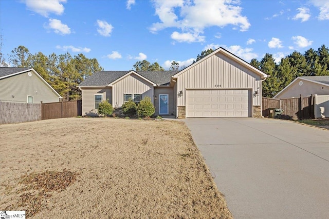 single story home with a garage and a front lawn