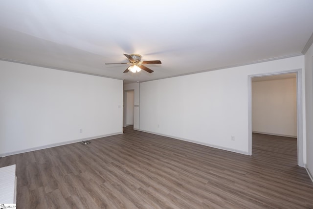 unfurnished room featuring ceiling fan, dark hardwood / wood-style flooring, and ornamental molding