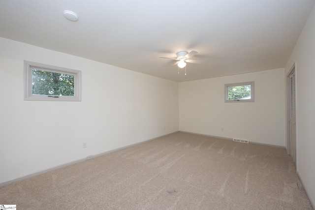 spare room with carpet flooring and ceiling fan