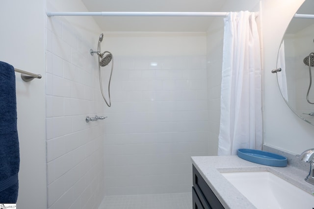 bathroom featuring curtained shower and vanity