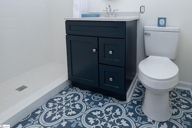 bathroom with vanity, toilet, a shower, and tile patterned flooring