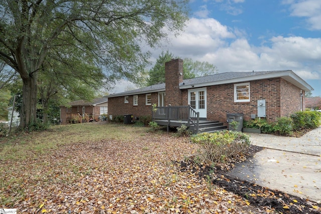 rear view of property featuring a deck