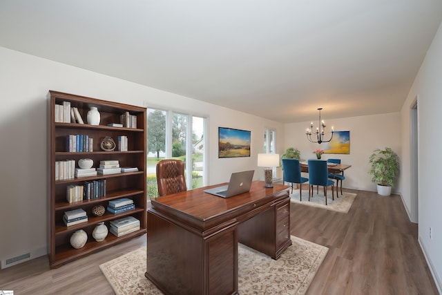 office space with hardwood / wood-style flooring and a chandelier