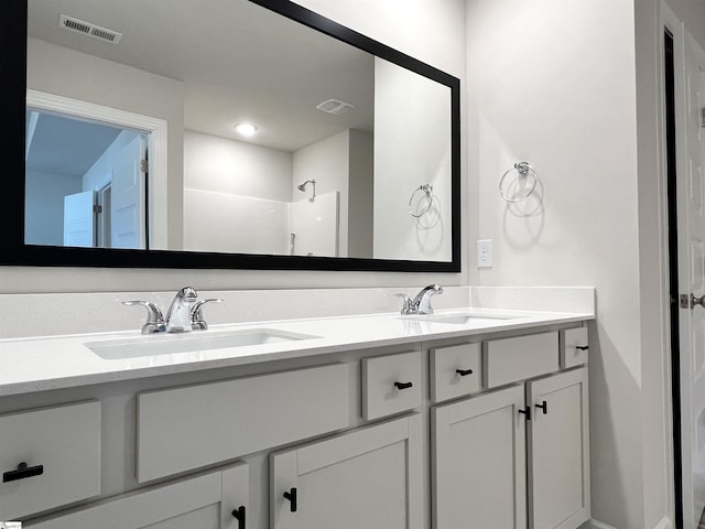 bathroom featuring vanity and a shower