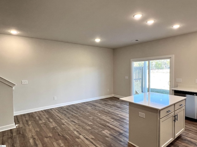 kitchen featuring dark wood-type flooring, white cabinets, dishwasher, and a kitchen island