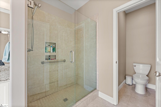 bathroom featuring toilet, a shower with door, and tile patterned flooring