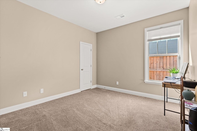 unfurnished office with carpet flooring and a healthy amount of sunlight