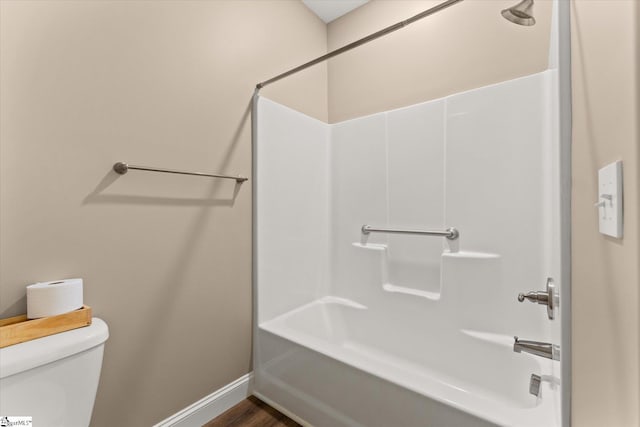 bathroom with toilet, shower / tub combination, and hardwood / wood-style flooring