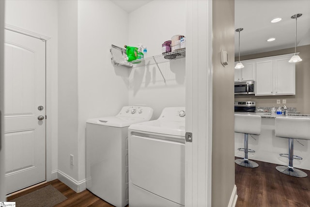 laundry room featuring dark wood-type flooring and washer and dryer