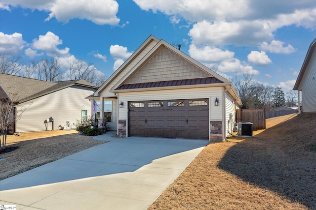 view of front of home with central AC and a garage