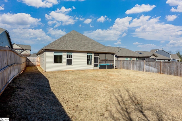 back of house featuring a lawn