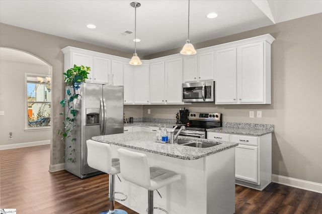 kitchen with white cabinets, light stone countertops, and appliances with stainless steel finishes