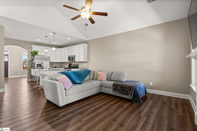 living room with ceiling fan, high vaulted ceiling, and dark wood-type flooring