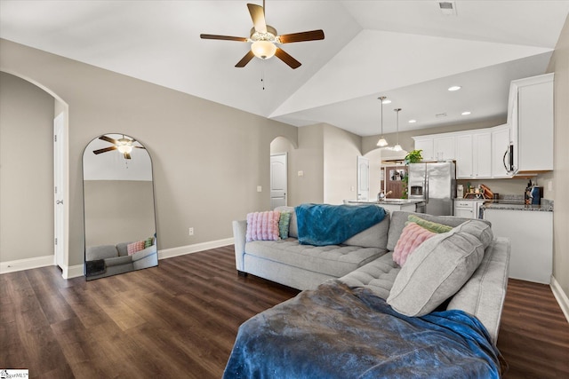 living room featuring ceiling fan, dark hardwood / wood-style floors, and lofted ceiling