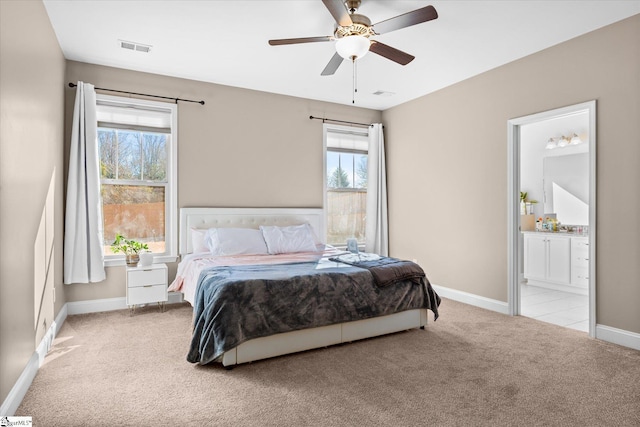 bedroom featuring ceiling fan, ensuite bathroom, and light carpet