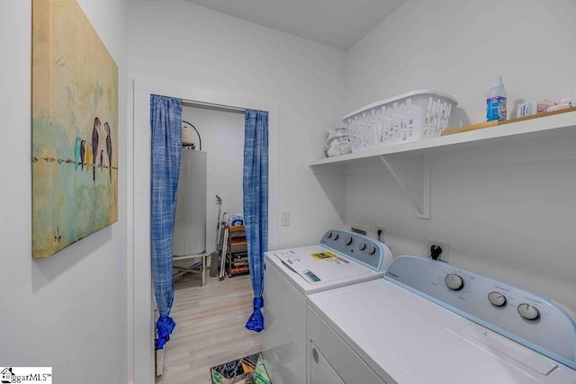 clothes washing area with light hardwood / wood-style flooring and separate washer and dryer