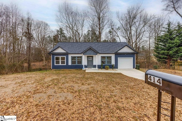 ranch-style home featuring a garage and a front yard