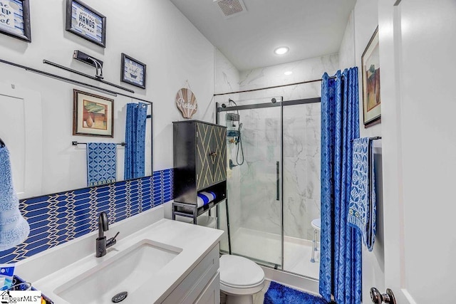 bathroom featuring toilet, an enclosed shower, and vanity