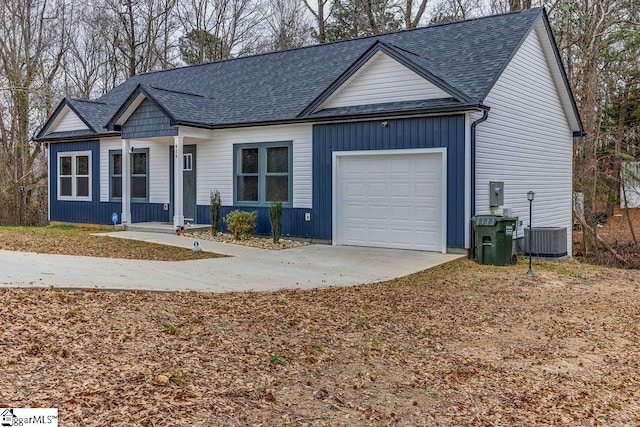 ranch-style home with a garage and central AC