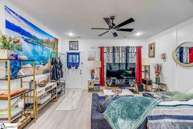 living room with ceiling fan and wood-type flooring