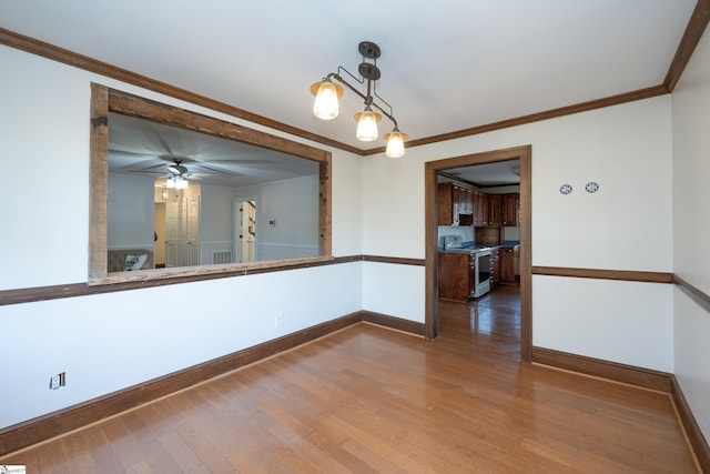 interior space with crown molding, wood-type flooring, and ceiling fan