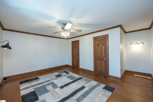 unfurnished bedroom with ornamental molding, dark hardwood / wood-style floors, and ceiling fan